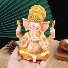 Gouden en roze Ganesha olifant beeldje, een prachtige decoratie die rust en spirituele energie toevoegt aan je interieur.